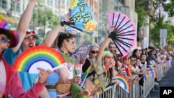 Revelers cheer along the route during a Pride Parade, in San Francisco, California, June 30, 2024.