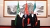 Ali Shamkhani, the secretary of Iran's Supreme National Security Council, right, shakes hands with Saudi national security adviser Musaad bin Mohammed al-Aiban, left, as Wang Yi, China's most senior diplomat, stands in the middle, Beijing, March 11, 2023. 