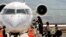 FILE - A picture taken on March 20, 2018 shows passengers climbing aboard a plane on the tarmac at the airport in the Iraqi Kurdish city of Suleimaniyah.