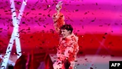 Swiss singer Nemo, representing Switzerland with the song "The Code," celebrates after winning the final of Eurovision 2024 at the Malmo Arena in Malmo, Sweden, May 11, 2024.