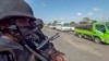 FILE - In this image made from video, police patrol a road in Palma, Cabo Delgado province, Mozambique, Aug. 15, 2021. The United Nations says jihadist violence in the region has forced more than a million people to flee their homes. 