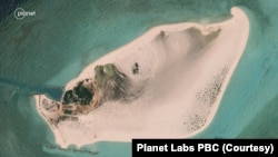 Although satellite imagery of Triton Island taken by Planet Labs PBC in August 2023 shows what appears to be a runway or a roadway jutting toward the east, the new structure is not visible in this satellite photo of Triton Island taken by Planet Labs PBC in March 2023.