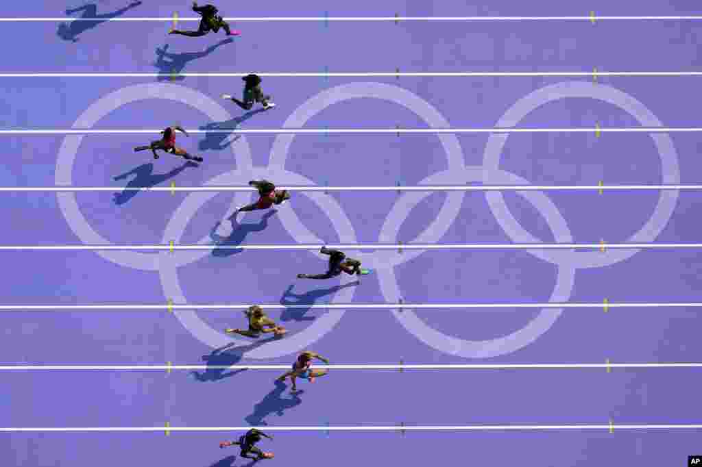 Sha'carri Richardson, right, of the United States, runs in women's 100-meter heat at the 2024 Summer Olympics, in Saint-Denis, France.