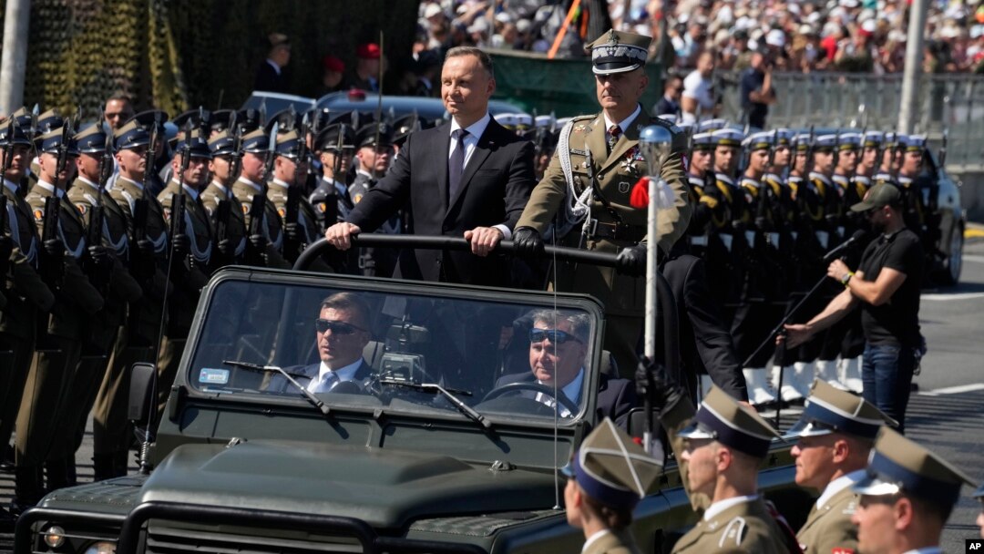 Poland's President Andrzej Duda greets troops as he arrives for a massive military parade that was to show Poland's defense potential as war is raging in neighboring Ukraine, in Warsaw, Poland, on Aug. 15, 2023.
