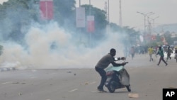 FILE - Police fired tear gas during a protest in Abuja, Aug. 1, 2024. Nigeria’s leader on Aug. 4, called for an end to mass protests against the West African nation’s economic hardship. 