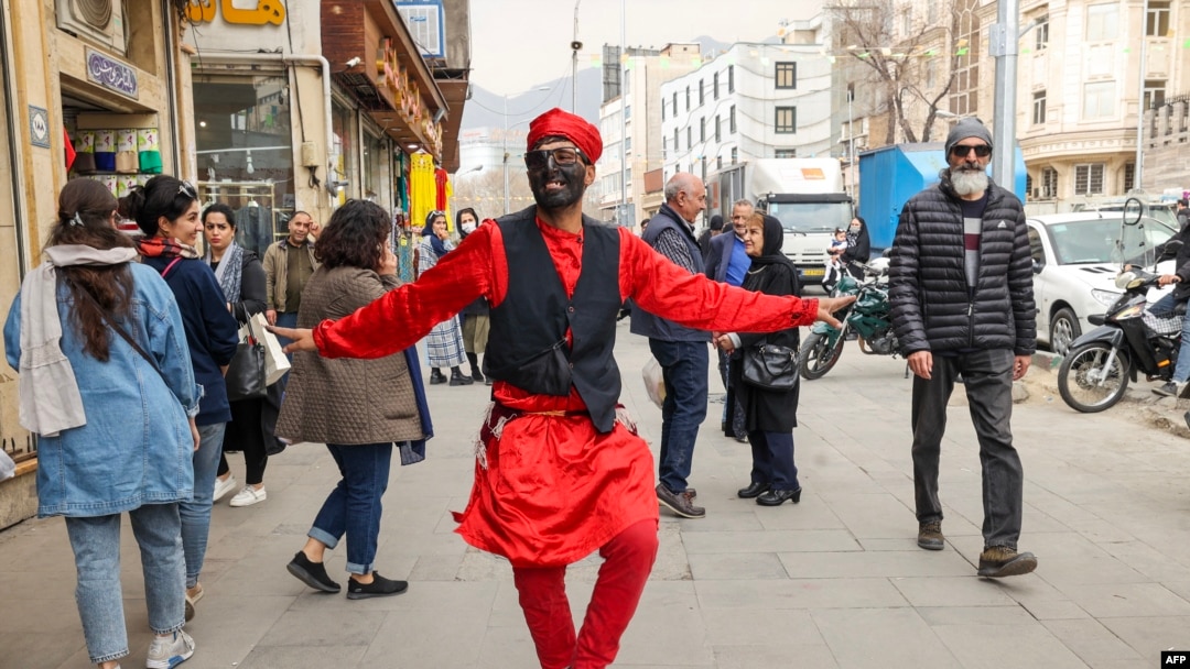 A man dressed as the folklore character Hajji Firuz performs in Tehran on March 14, 2023, ahead of the Nowruz New Year festival. Millions across the Middle East, Asia and Eastern Europe celebrate Nowruz new year festival, which marks the start of spring.