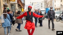 A man dressed as the folklore character Hajji Firuz performs in Tehran on March 14, 2023, ahead of the Nowruz New Year festival. Millions across the Middle East, Asia and Eastern Europe celebrate Nowruz new year festival, which marks the start of spring.