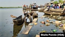 Trash and rotten boards litter the Nile River, in Bor, Jonglei State, South Sudan.