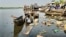 Trash and rotten boards litter the Nile River, in Bor, Jonglei State, South Sudan.
