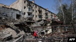 A person looks through the rubble of a building destroyed by bombing in the town of Kostyantynivka, Donetsk region, on April 11, 2024.