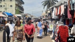 People browse at a market on the side of a road in Libreville on Sept. 2, 2023. Gabon's army said on Sept. 2, 2023, that it would reopen the country's borders, closed in the wake of the military coup that ousted ex-president Ali Bongo Ondimba.