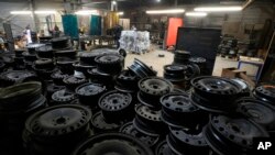 Volunteers weld a heating from old car rims in workshop in Siauliai, some 230 kilometers northwest of Vilnius, Lithuania, Feb. 2, 2023.