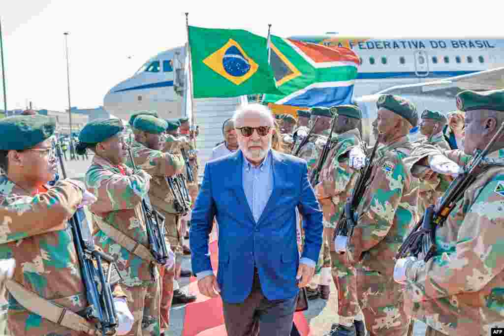 Soldiers of the South African National Defence Force make an honor guard as President of Brazil Luiz Inacio Lula da Silva arrives at the OR Tambo International Airport in Ekurhuleni, ahead of the 2023 BRICS Summit, in this handout photograph from the Brazilian Presidency.