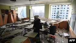 A teacher inspects her classroom, which was damaged after a missile attack in Lviv, western Ukraine, Dec. 29, 2023. Russia's drone and missile strikes across Ukraine that day killed at least 12 people.