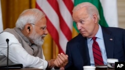 President Joe Biden speaks with India's Prime Minister Narendra Modi during a meeting with American and Indian business leaders in the East Room of the White House, June 23, 2023, in Washington.