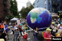 Activists mark the start of Climate Week in New York during a demonstration calling for the U.S. government to take action on climate change and reject the use of fossil fuels in New York City, Sept. 17, 2023.