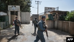 FILE - Security personnel stands guard outside United Nations Assistance Mission in Afghanistan (UNAMA) office compound in Guzara district of Herat province on July 31, 2021.