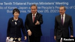 FILE - Then-South Korean Foreign Minister Park Jin escorts Chinese Foreign Minister Wang Yi and Japanese Foreign Minister Yoko Kamikawa prior to the 10th trilateral foreign ministers' meeting in Busan, South Korea, Nov. 26, 2023.