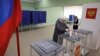 A woman votes at a polling station during a presidential election in Makiivka, Russian-controlled Donetsk region, eastern Ukraine, March 15, 2024. People in Moscow-controlled Ukrainian regions are voting in Russia's presidential election.