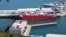 The Bibby Stockholm barge, foreground, at Portland, near Poole, Britain, Aug. 7, 2023. Asylum-seekers had been housed on the barge until traces of bacteria were found in the ship's water system. 