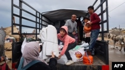 Palestinian pack their belongings as they prepare to flee Rafah in the southern Gaza Strip on May 13, 2024, amid the ongoing conflict between Israel and the Hamas militant group.