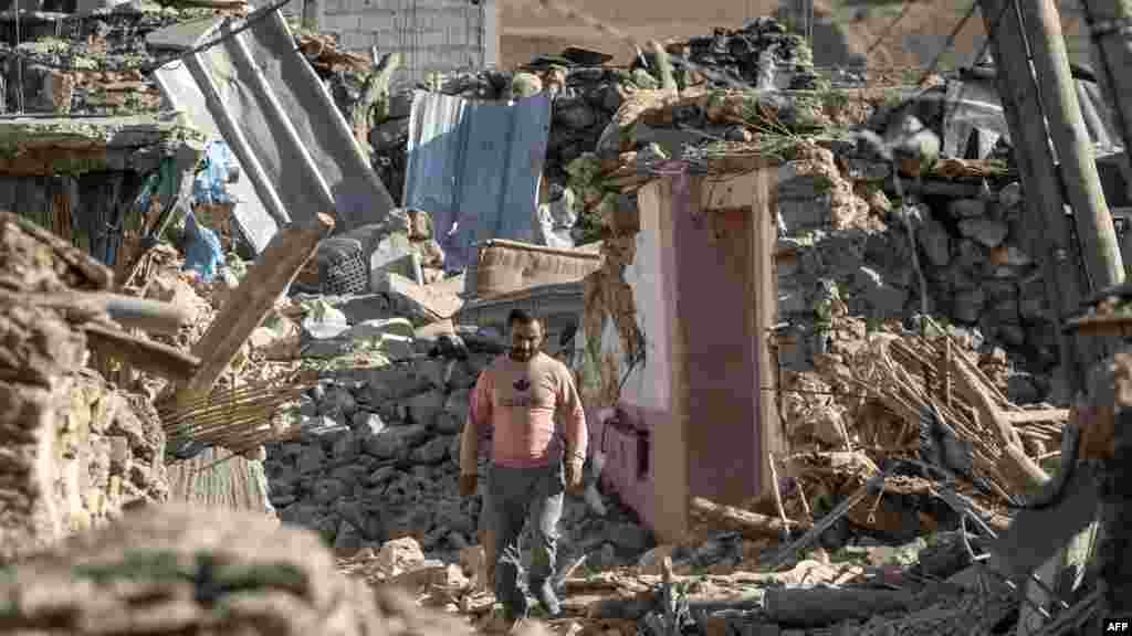 A man walks past destroyed houses after an earthquake in the mountain village of Tafeghaghte, southwest of the city of Marrakesh, Morocco, on Sept. 9, 2023. 