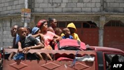 Residents evacuate the Carrefour Feuilles commune in Port-au-Prince, Haiti, on Aug. 15, 2023, as gang violence continues to plague the Haitian capital.