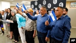 FILE - Recently released political prisoners from Nicaragua stand during a news conference at the office of Miami-Dade County Mayor in Miami, Feb. 15, 2023. Nicaraguan President Daniel Ortega recently sent 222 political prisoners to the United States. 