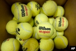 A box of game-used tennis balls rest in a shipping box during the U.S. Open tennis championships, Monday, Sept. 4, 2023, in New York. (AP Photo/Eduardo Munoz Alvarez)
