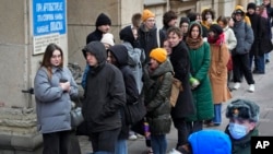 Voters queue at a polling station in St. Petersburg, Russia, March 17, 2024.