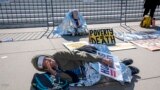 Activists demonstrate at the Supreme Court as the justices consider a challenge to rulings that found punishing people for sleeping outside when shelter space is lacking amounts to unconstitutional cruel and unusual punishment, in Washington, Monday, April 22, 2024. 