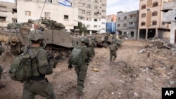 FILE - Israeli soldiers take part in a ground operation in Gaza City's Shijaiyah neighborhood, Dec. 8, 2023. U.S. Secretary of State Antony Blinken has approved an emergency weapons sale to Israel as Israel continues its war against Hamas in Gaza. 