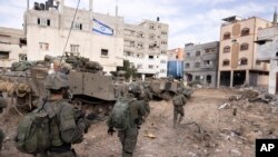 FILE - Israeli soldiers take part in a ground operation in Gaza City's Shijaiyah neighborhood, Dec. 8, 2023.
