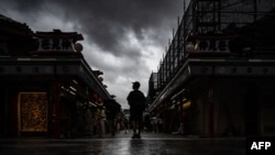 People visit Sensoji temple in Tokyo's Asakusa district on Aug. 16, 2024, as Typhoon Ampil barrels towards Japan's capital. 