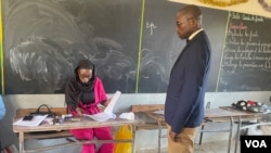 Ndoumbe Gueye verifies a voter information, March 24, 2024, in Dakar. (Mariama Diallo/VOA)