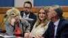 Jenna Ellis reacts with her lawyers after reading a statement inside Fulton Superior Court Judge Scott McAfee's Fulton County Courtroom, Oct. 24, 2023, in Atlanta. 