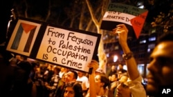 FILE - Demonstrators from a nearby pro-Palestinian rally join a protest in New York on Aug. 20, 2014, against the police shooting death of Michael Brown in Ferguson, Mo.