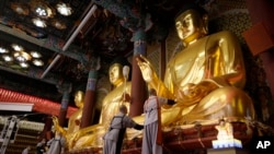 Buddhists monks clean Buddha statues ahead of the upcoming birthday of Buddha on May 15, at the Jogye temple in Seoul, South Korea, May 7, 2024. 