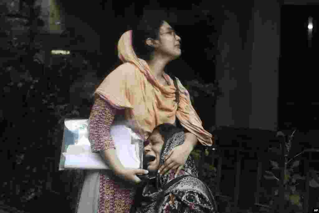 Sanjida, left, consoles her mother as she breaks into tears after receiving the dead body of her son, who was shot during a clash between the police and anti-quota protesters, at a morgue in Dhaka, Bangladesh, July 22, 2024. (AP Photo/Anik Rahman)