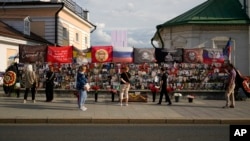 People stand near an improvised memorial to the late Russian mercenary chief Yevgeny Prigozhin in Moscow, July 29, 2024. The Wagner mercenary group suffered its heaviest loss in Africa's Sahel at the end of July following a rebel attack.