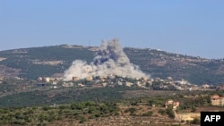 Smoke billows following an Israeli airstrike in the southern Lebanese border village of Chihine, July 28, 2024. Deadly cross-border exchanges have escalated between Israeli troops and mainly Hezbollah fighters on the Israel-Lebanon frontier.