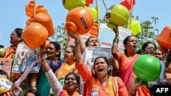 Activists and members of the Bharatiya Janata Party (BJP) hold empty water pots as they shout slogans during a protest against the state government over ongoing severe water crisis, in Bengaluru, India.