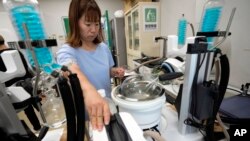 A staff of Mothers' Radiation Lab Fukushima, a citizens' testing center, tests seawater taken near the Fukushima Daiichi nuclear power plant, damaged by a massive March 11, 2011, earthquake and tsunami, in Iwaki, northeastern Japan on Aug. 25, 2023.