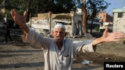 A Palestinian man reacts at the site of an Israeli strike, outside a school sheltering displaced people, amid the Israel-Hamas conflict, in Khan Younis in the southern Gaza Strip, July 10, 2024.