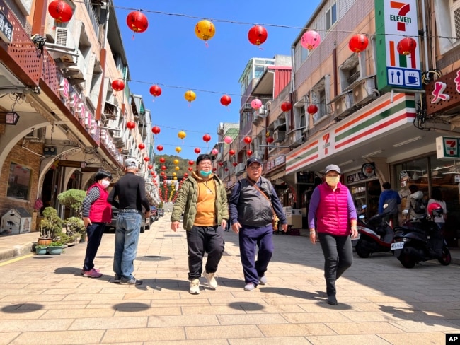 Tourists were seen walking on the street in the shopping district on Nangan, part of Matsu Islands, Taiwan on Tuesday, March 7, 2023. (AP Photo/Johnson Lai)