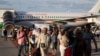 People evacuated from Israel on a Bulgarian government plane react after arriving at Sofia International Airport, in Sofia, Bulgaria, Oct. 8, 2023. 