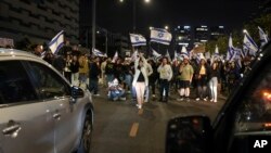 Demonstrators block a road during a protest against Israeli Prime Minister Benjamin Netanyahu's government in Tel Aviv, Israel, March 2, 2024. 