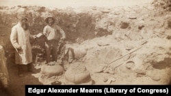 This circa 1884-1886 photo by Army surgeon/naturalist Edgar Alexander Mearns shows two unidentified men, possibly Mearns himself on right, excavating pre-Columbian ruins in central Arizona's Verde River Valley.
