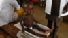 FILE - Health officials measure a malnourished baby at a health clinic in Nigeria, on Sept. 21, 2021. Doctors Without Borders warns that severe malnutrition has increased dramatically in Bauchi state between January and June 2024.