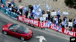 Protesters rally outside Tesla’s Fremont factory in California as Israeli Prime Minister Benjamin Netanyahu plans a visit with businessman Elon Musk, Sept. 18, 2023.